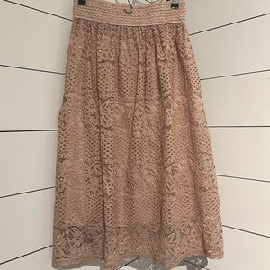 Pink laced skirt below the knee.